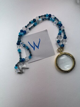 Magnifying glass with blue pearls and quartz neclace